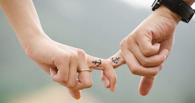 Cute couple holding hands, fingers