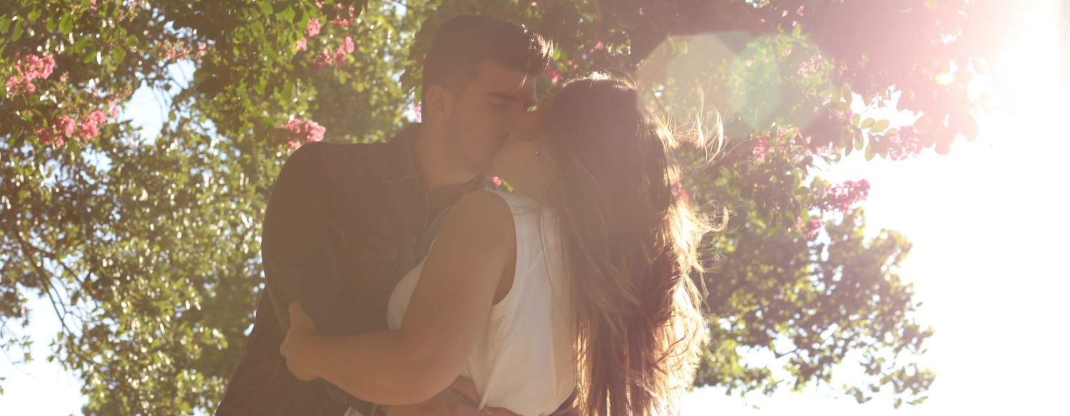 Couple kissing under a tree