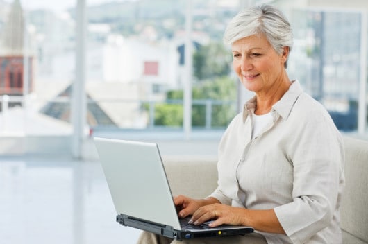 Senior lady dating online on her laptop